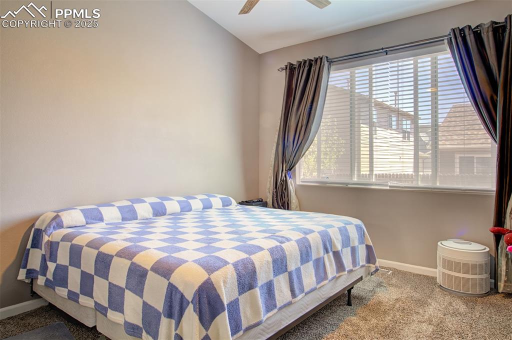 Image 9 of 21: Bedroom featuring carpet flooring, lofted ceiling, and a ceiling fan