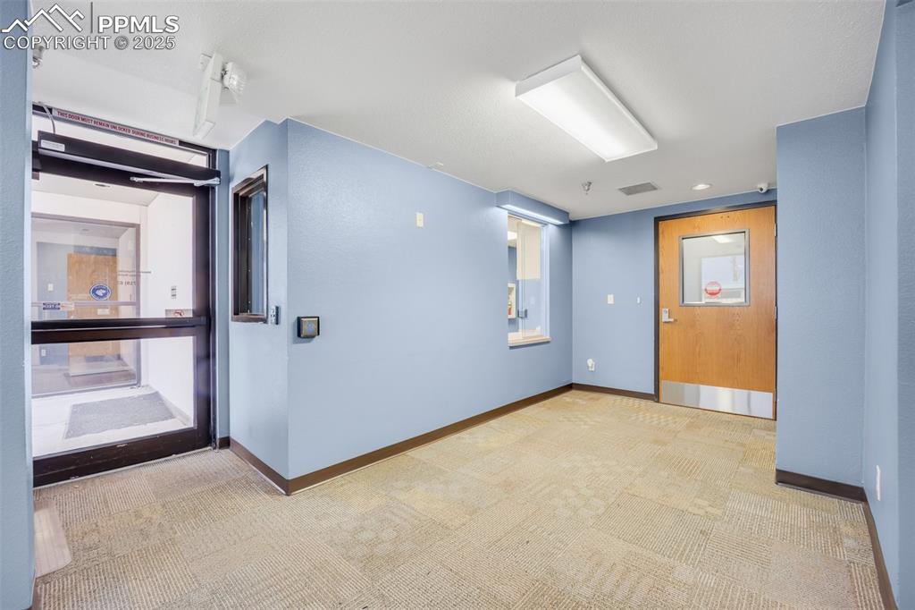 Image 26 of 49: Unfurnished room featuring carpet and fire sprinkler in ceiling