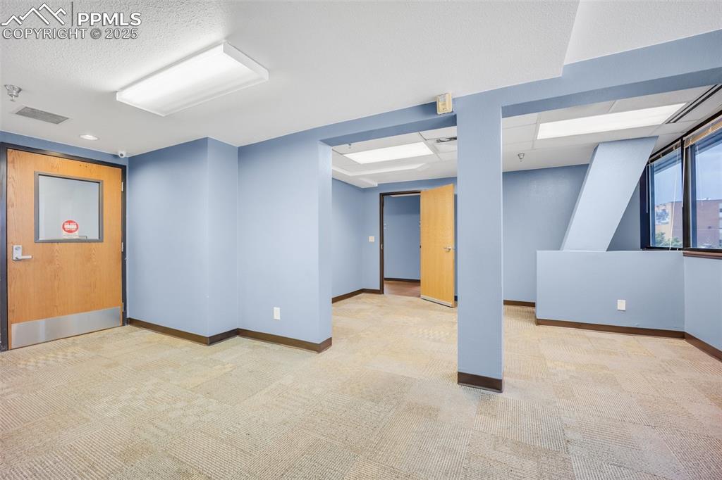 Image 27 of 49: Below grade area with baseboards and carpet