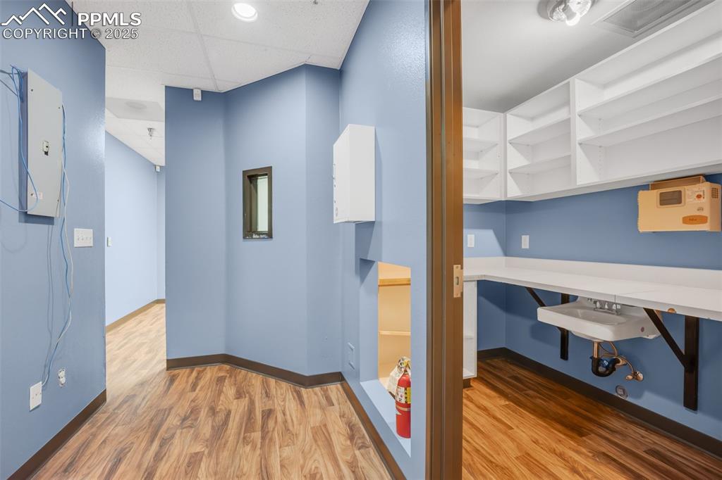 Image 32 of 49: Unfurnished bedroom featuring wood finished floors and a drop ceiling