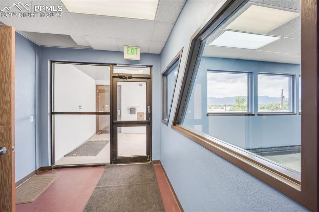 Image 37 of 49: Hall featuring a paneled ceiling and carpet