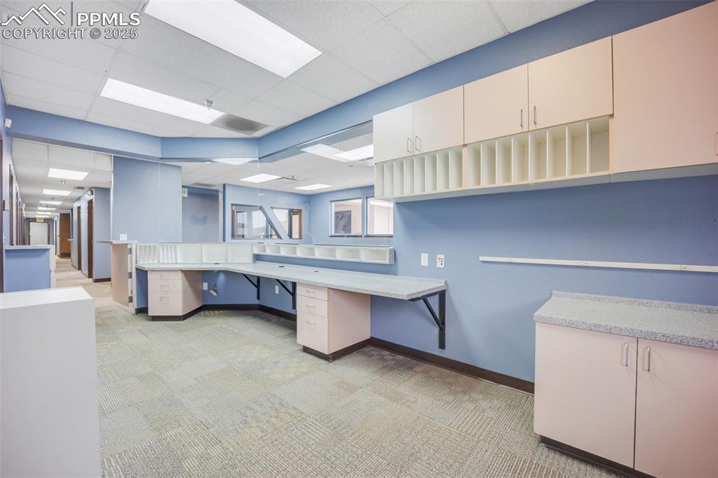 Image 40 of 49: Office featuring light carpet, built in study area, and a paneled ceiling