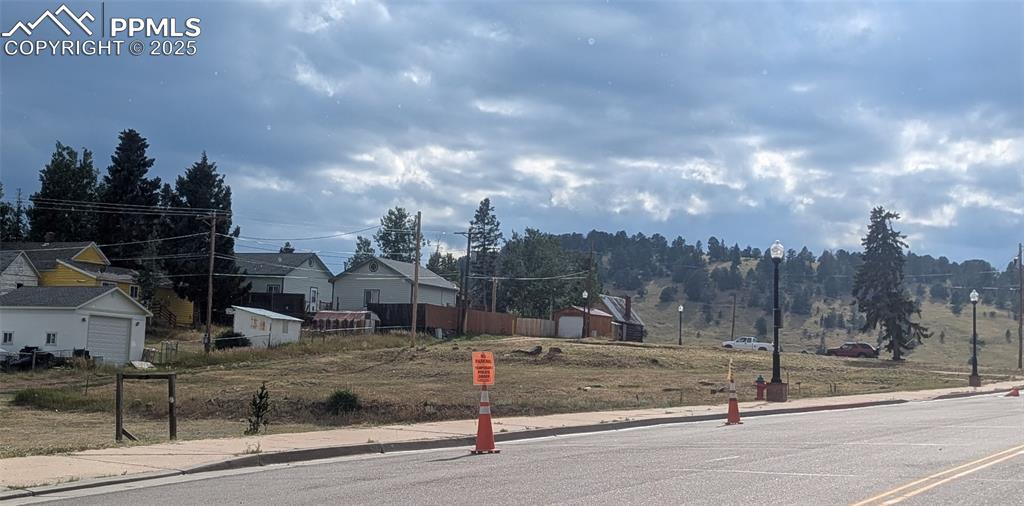 Image 2 of 9: Paved streets with curbs, sidewalks, street lights and city utilities