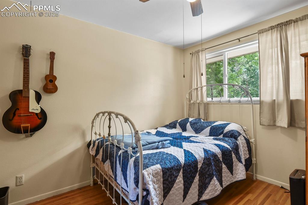 Image 17 of 30: Bedroom featuring wood finished floors and a ceiling fan