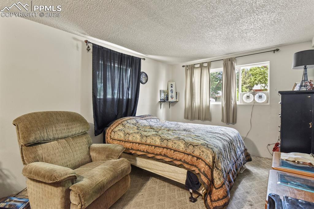 Image 18 of 30: Bedroom featuring a textured ceiling