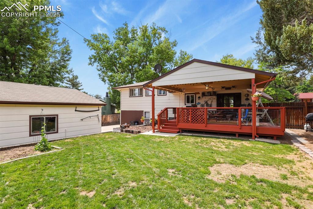 Image 21 of 30: Back of house with a ceiling fan and a deck