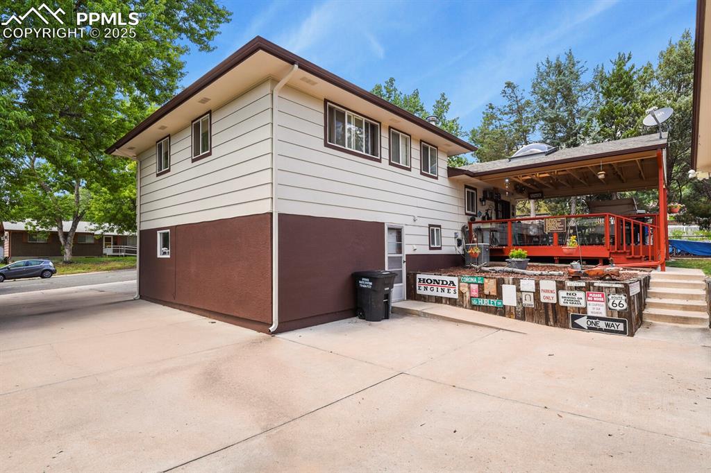 Image 25 of 30: View of property exterior featuring a wooden deck