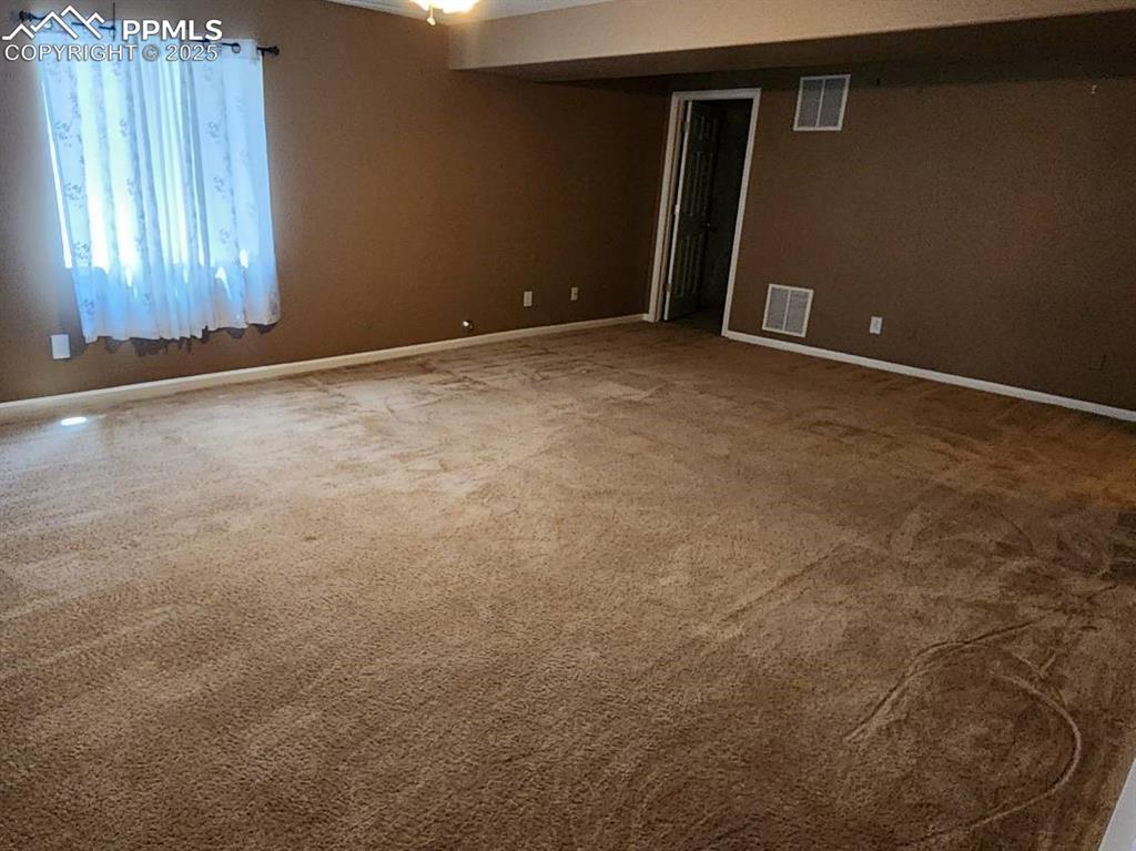Image 13 of 17: Carpeted empty room with baseboards