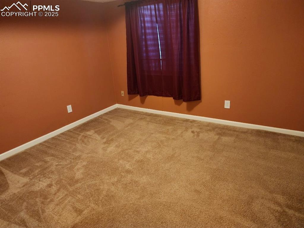 Image 14 of 17: Unfurnished room featuring baseboards and carpet floors