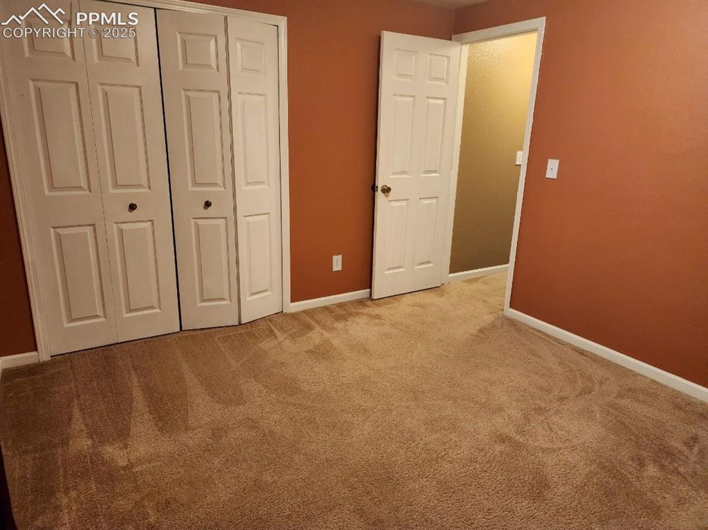 Image 18 of 20: Unfurnished bedroom with light colored carpet and a closet