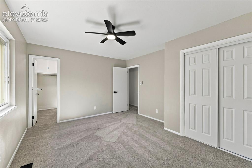 Image 13 of 30: Recessed window, ceiling fan with integrated lighting, neutral wall paint, 