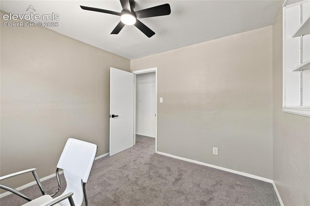 Image 17 of 30: Neutral-toned walls complement the gray carpeting