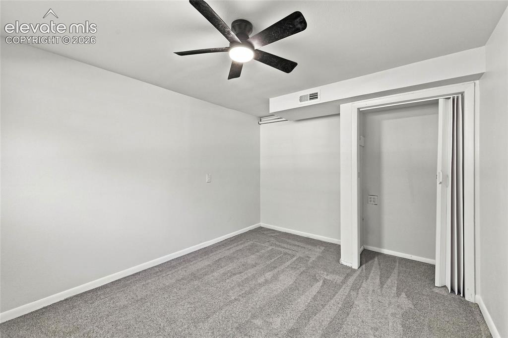 Image 21 of 30: Ceiling fan with integrated lighting, neutral wall paint, gray patterned ca
