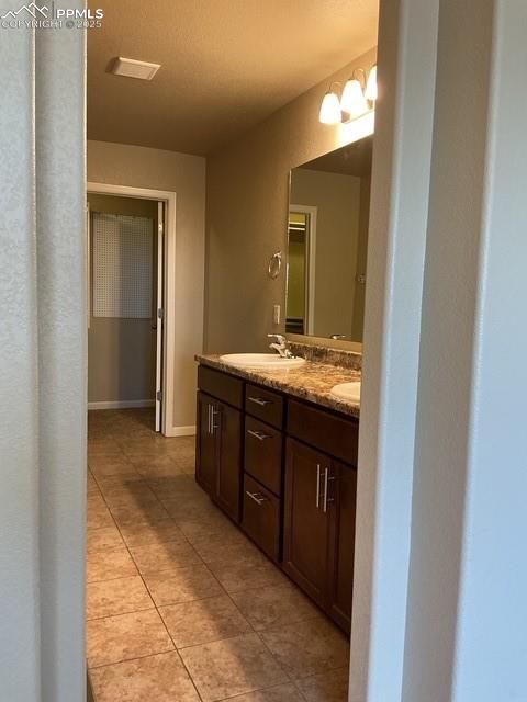 Image 20 of 37: Full bath featuring double vanity and light tile patterned flooring