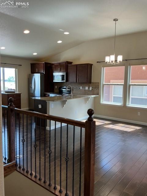 Image 24 of 37: Looking into kitchen dining living area from hall