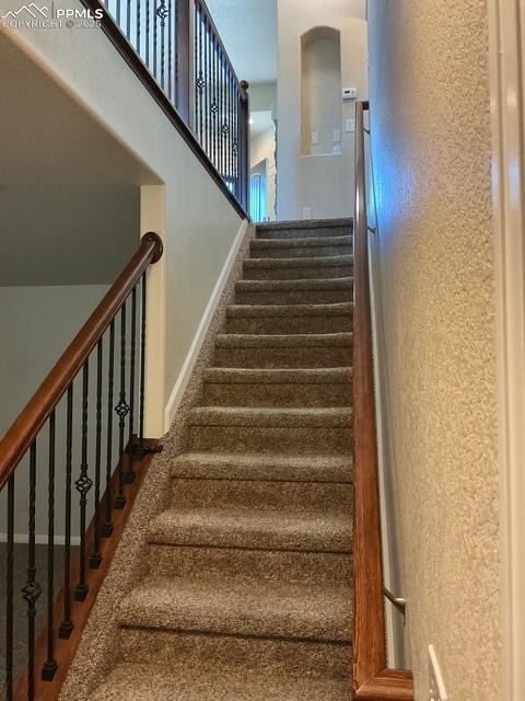Image 36 of 37: Staircase featuring baseboards