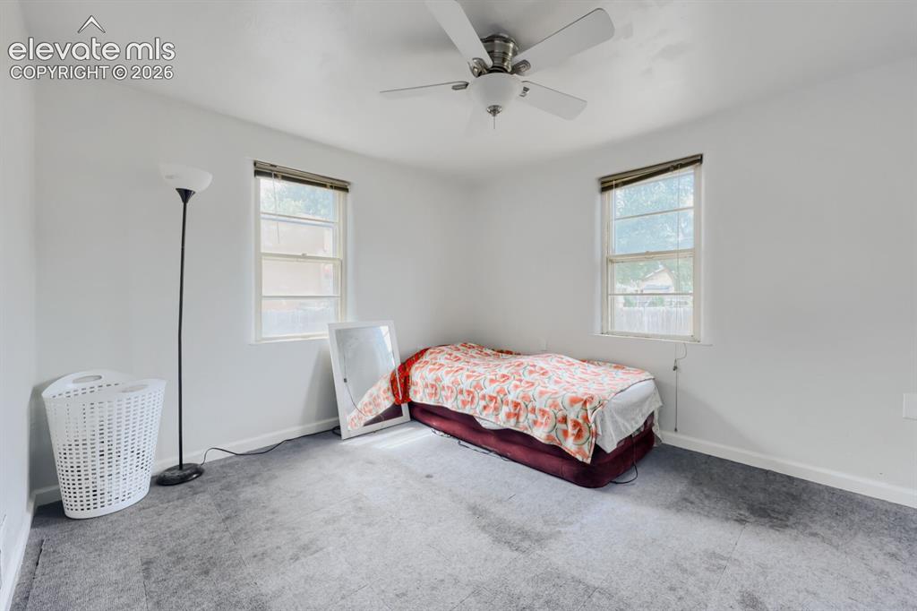 Image 22 of 36: Recessed lighting, two windows with blinds, and a ceiling fan with light