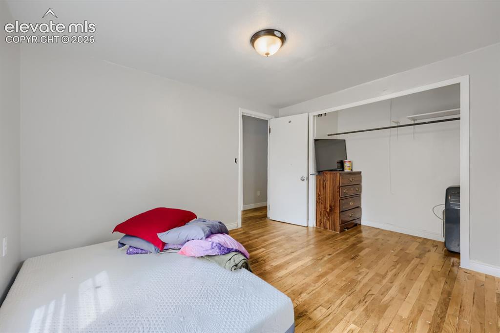 Image 25 of 36: Wood-finish flooring, light gray wall paint, and a semi-flush mount ceiling