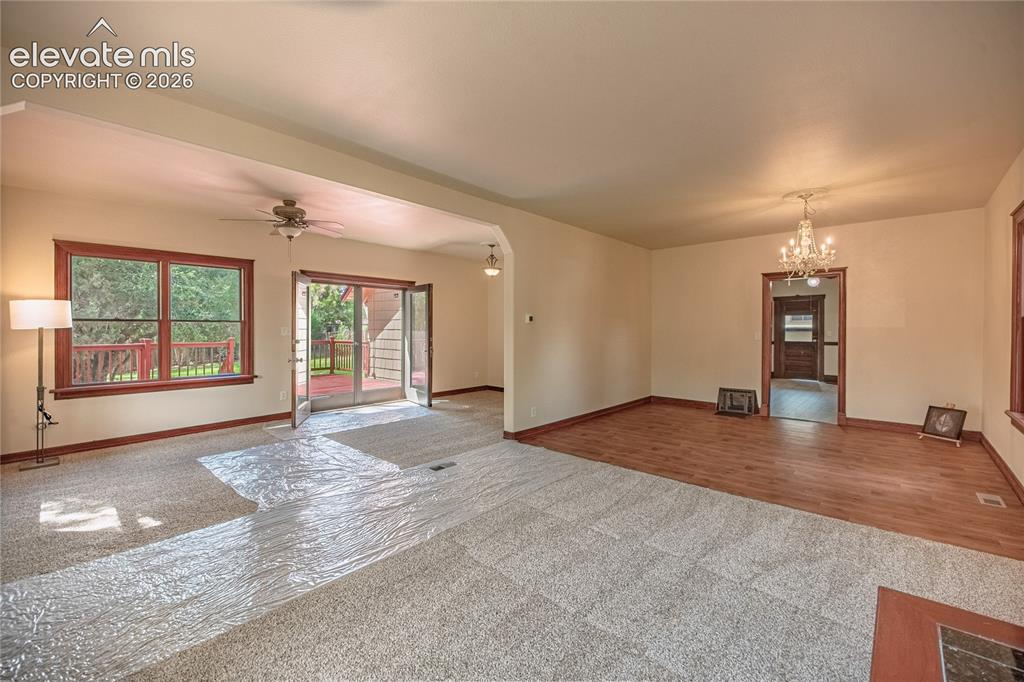 Image 10 of 47: Expansive interior featuring carpeted and wood-finish flooring, a ceiling f