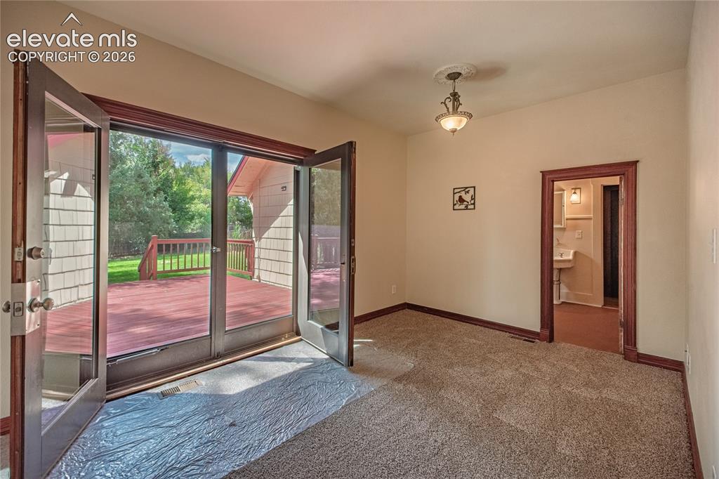 Image 13 of 47: French Door Walk-Out to Huge Wood Deck