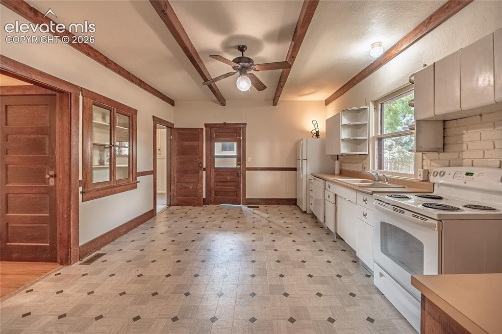 Image 3 of 47: Kitchen featuring exposed wood-finish ceiling beams, ceiling fan with integ