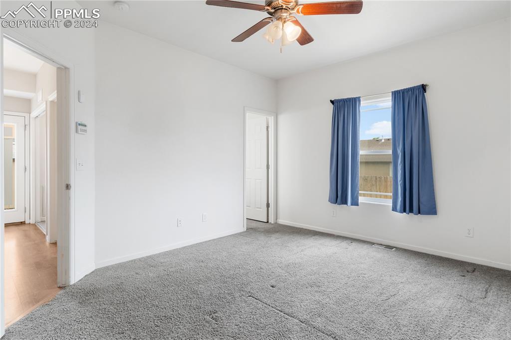 Image 11 of 30: Spare room with ceiling fan and carpet floors