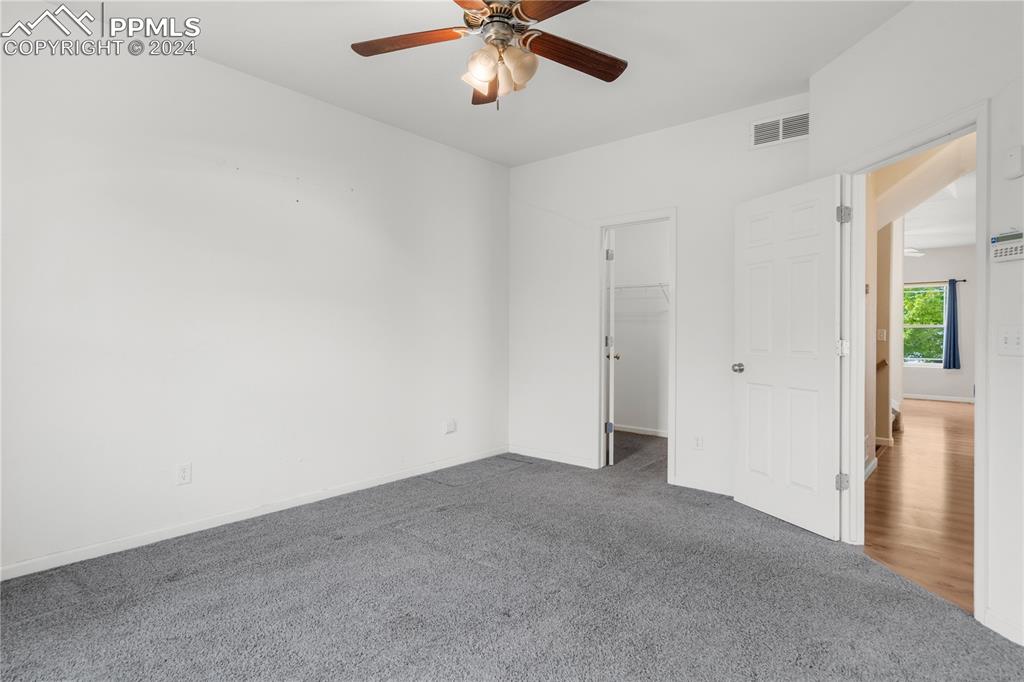 Image 12 of 30: Carpeted empty room with ceiling fan