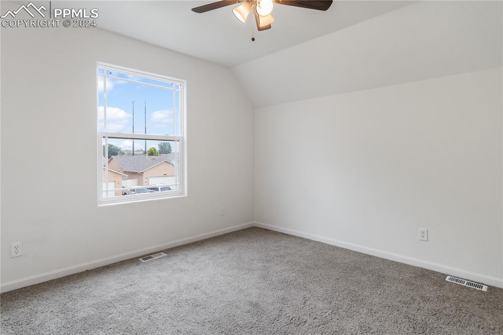 Image 17 of 30: Bonus room with carpet, ceiling fan, and vaulted ceiling