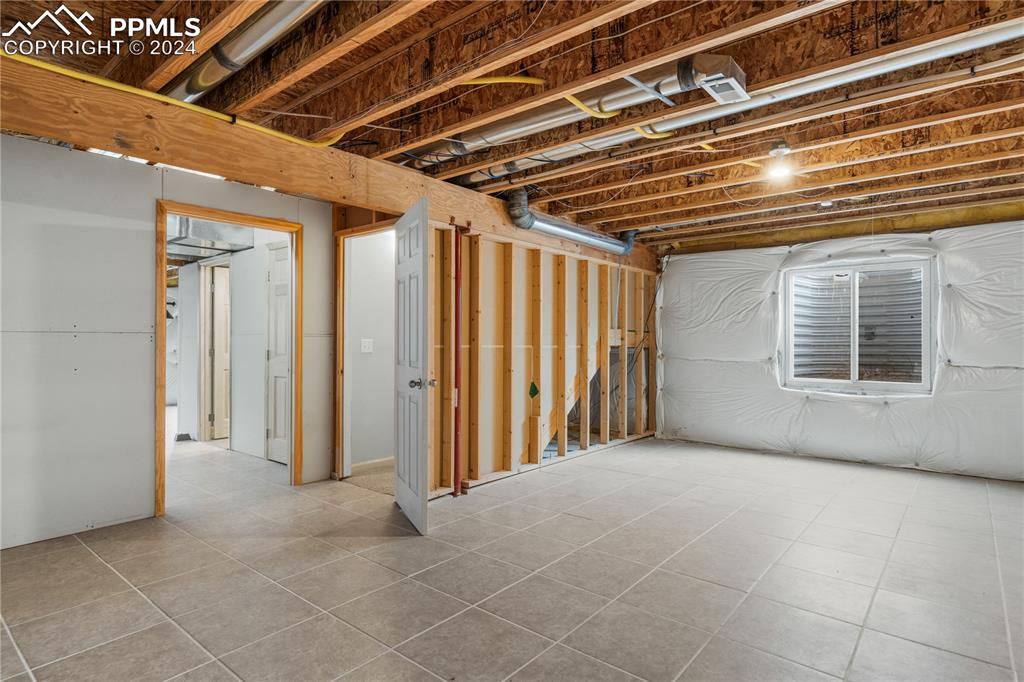 Image 22 of 30: Basement with tile flooring