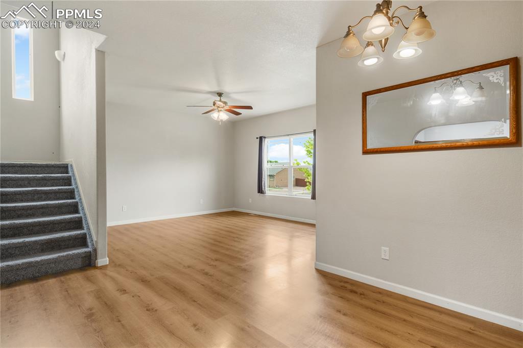 Image 6 of 30: Spare room featuring hardwood / wood-style flooring and ceiling fan with no