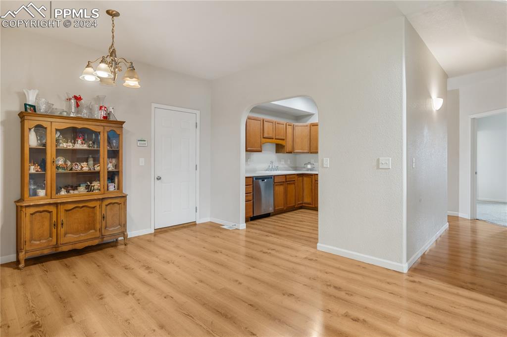 Image 7 of 30: Unfurnished dining area featuring light hardwood / wood-style floors, sink,