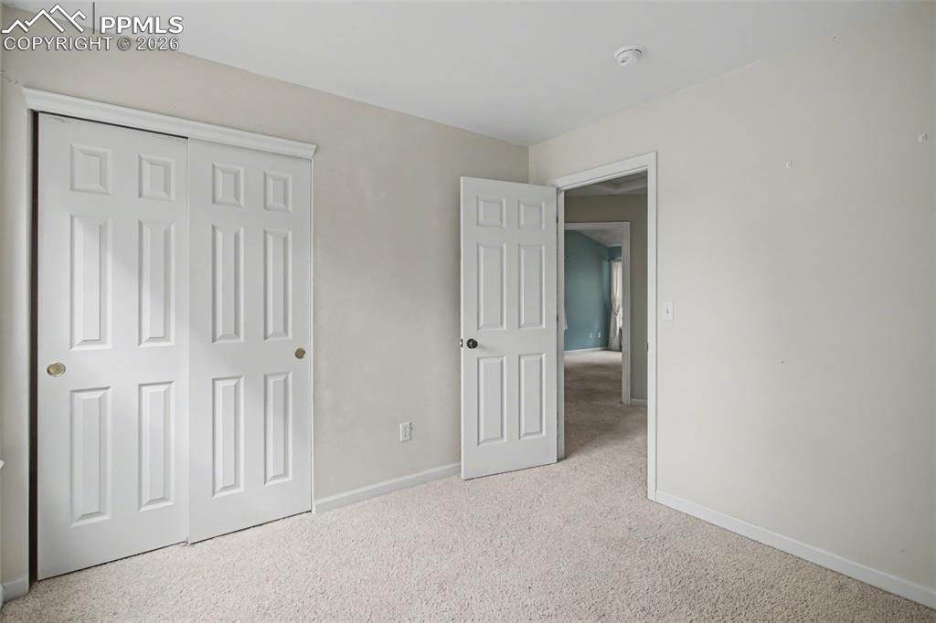 Image 17 of 49: Unfurnished bedroom with light carpet and a closet