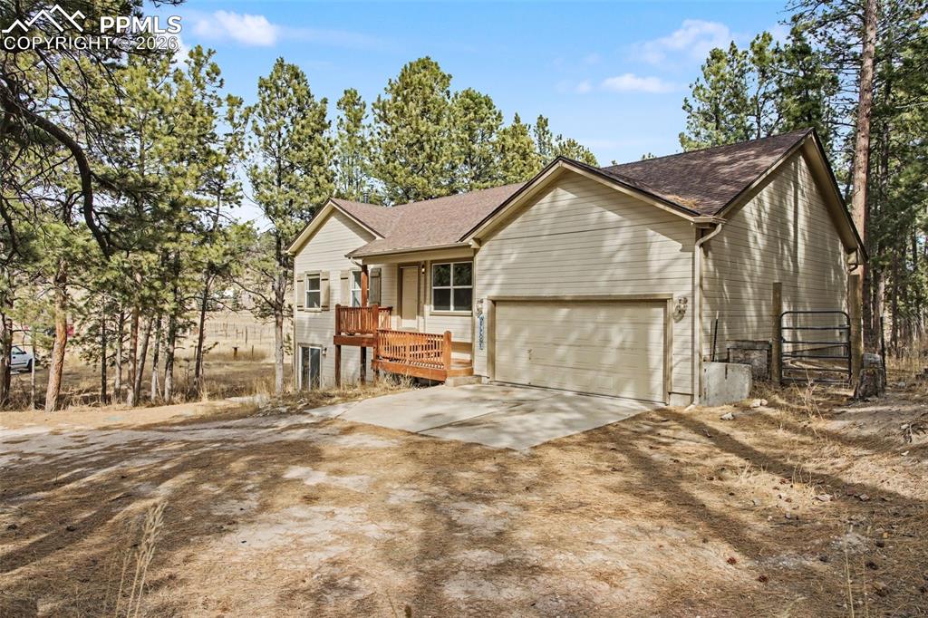 Image 2 of 49: Ranch-style home with concrete driveway, a garage, a shingled roof, and a w