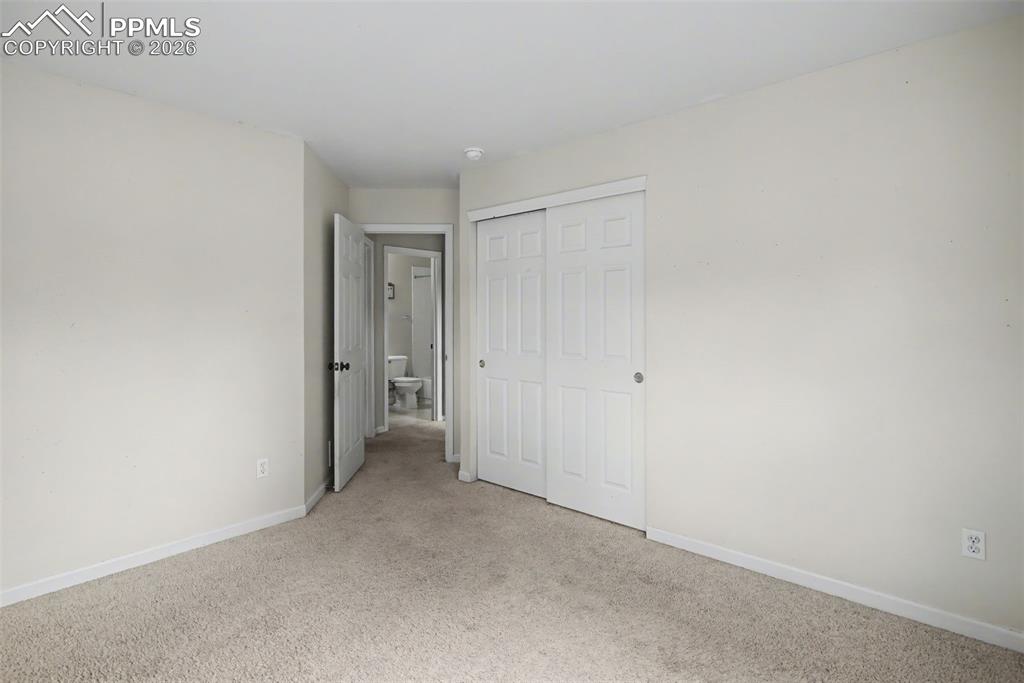 Image 20 of 49: Unfurnished bedroom featuring light colored carpet and a closet