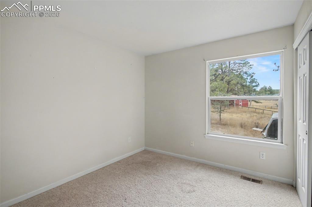 Image 21 of 49: Empty room featuring baseboards and carpet flooring