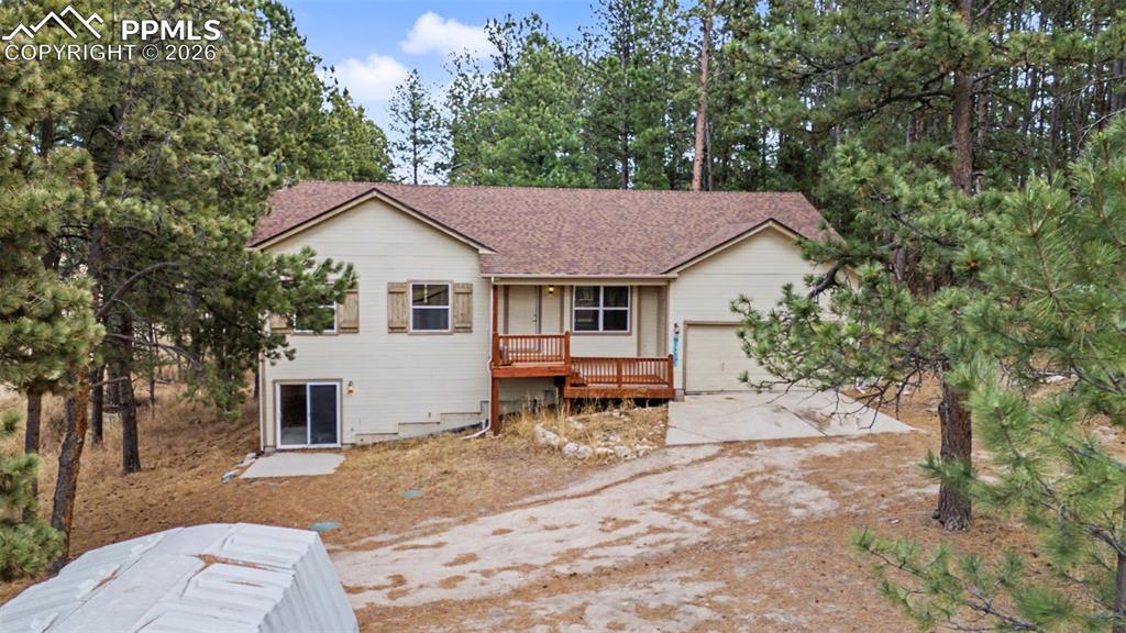 Image 32 of 49: Ranch-style home with concrete driveway, an attached garage, and a shingled