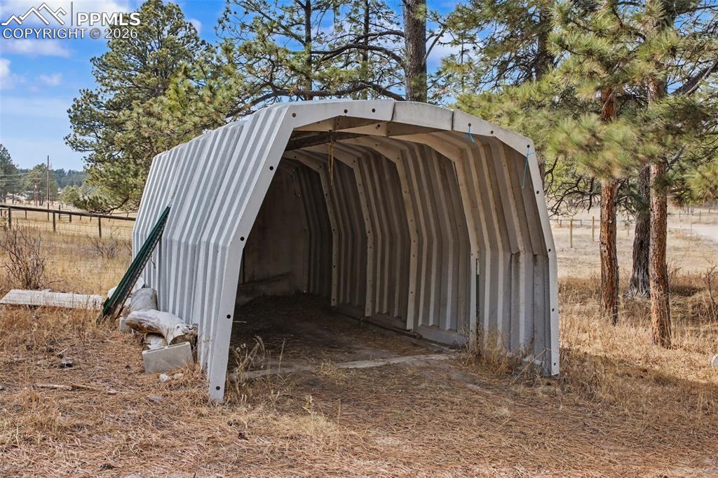 Image 39 of 49: View of outbuilding with a carport