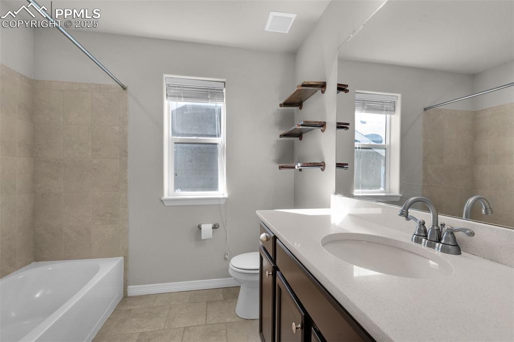 Image 20 of 38: Full bathroom featuring vanity, shower / bathtub combination