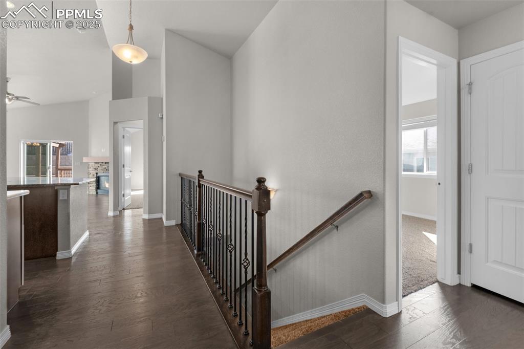 Image 3 of 38: Hallway featuring dark wood finished floors, and high vaulted ceiling