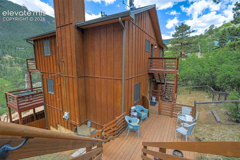 Image 34 of 43: Lower Rear Deck and fenced back yard