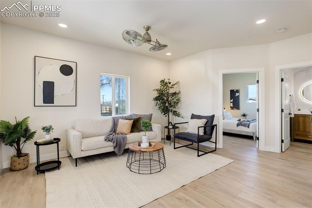Image 14 of 50: Living room featuring light wood-style floors, recessed lighting, and baseb