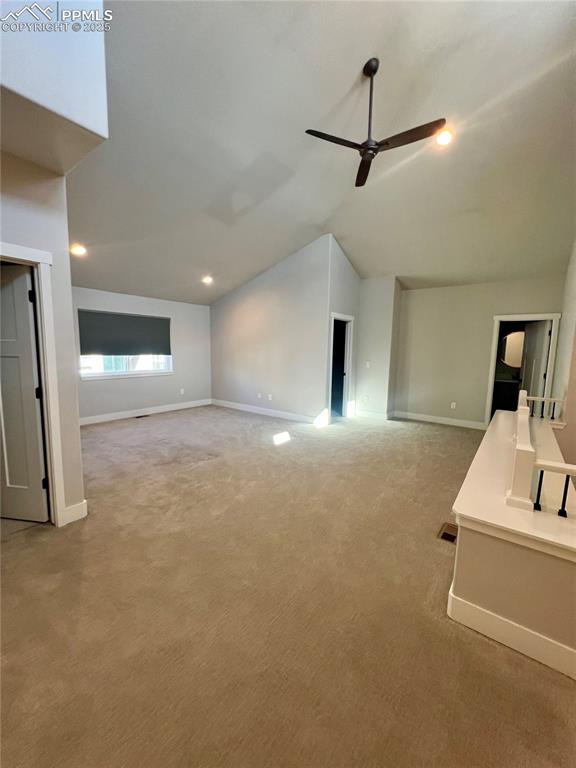 Image 9 of 19: Unfurnished loft with vaulted ceiling, carpet floors, recessed lighting, an