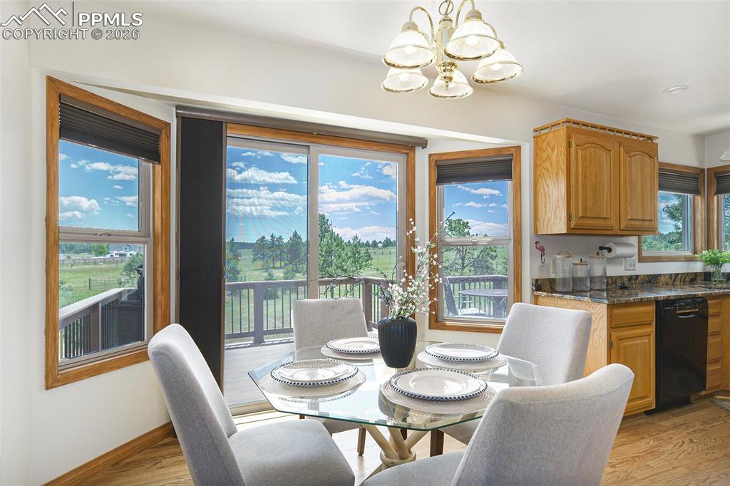 Image 16 of 49: Kitchen nook leads to sliding glass door and the spacious deck