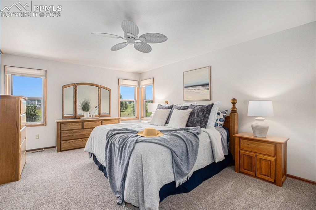 Image 20 of 49: Retreat to the main-level primary suite