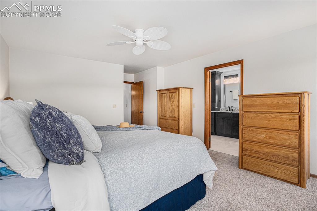 Image 21 of 49: Retreat to the main-level primary suite with double closets