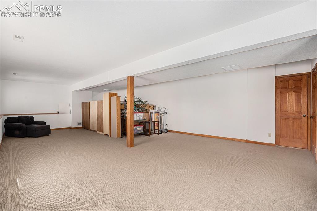 Image 30 of 49: Large windows throughout the basement fill it with natural light.