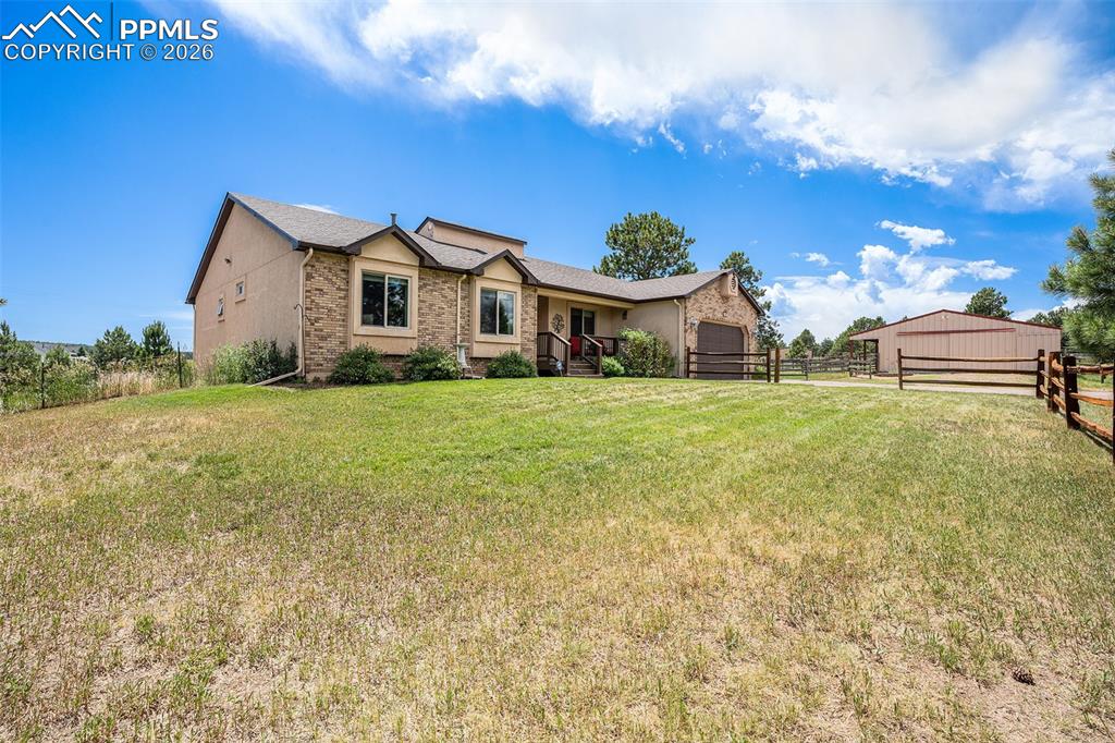 Image 45 of 49: Enjoy mature trees and fenced acreage designed for both recreation and hors