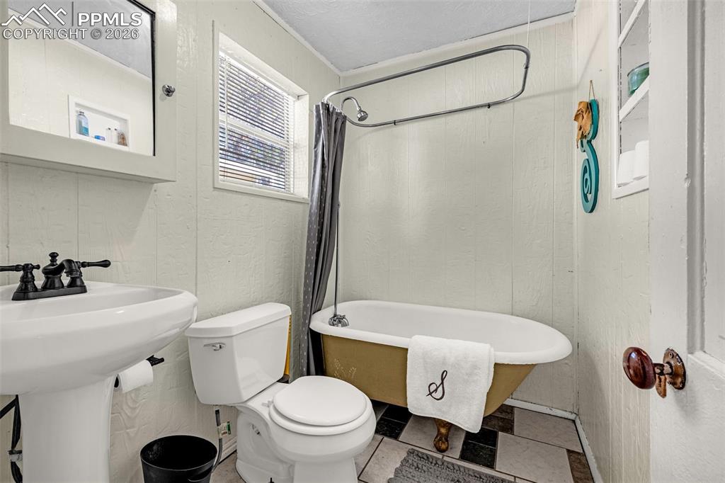 Image 8 of 29: Downstairs, claw foot tub!