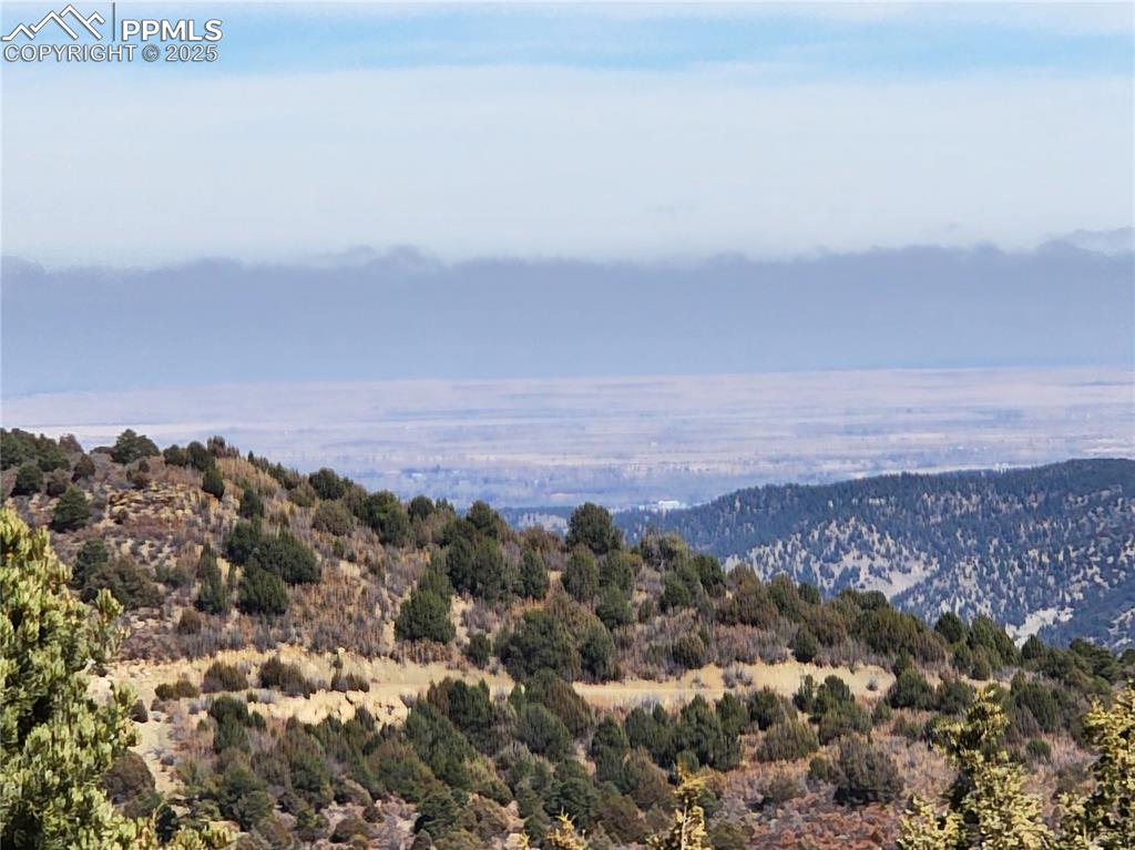 Image 19 of 23: Mountain view with a heavily wooded area