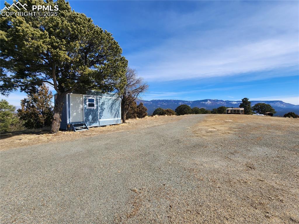 Image 3 of 23: View of dirt / gravel road featuring a mountain view